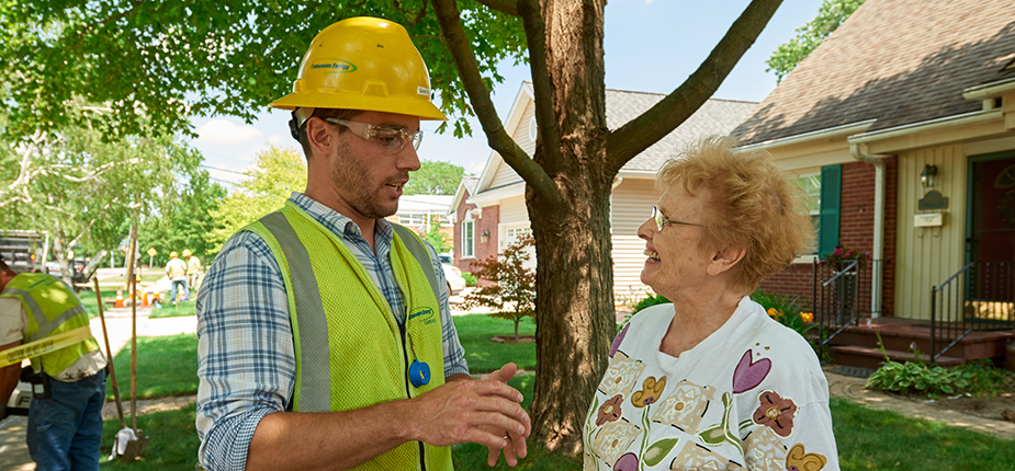 Consumers Energy employee with picture ID talking to homeowner